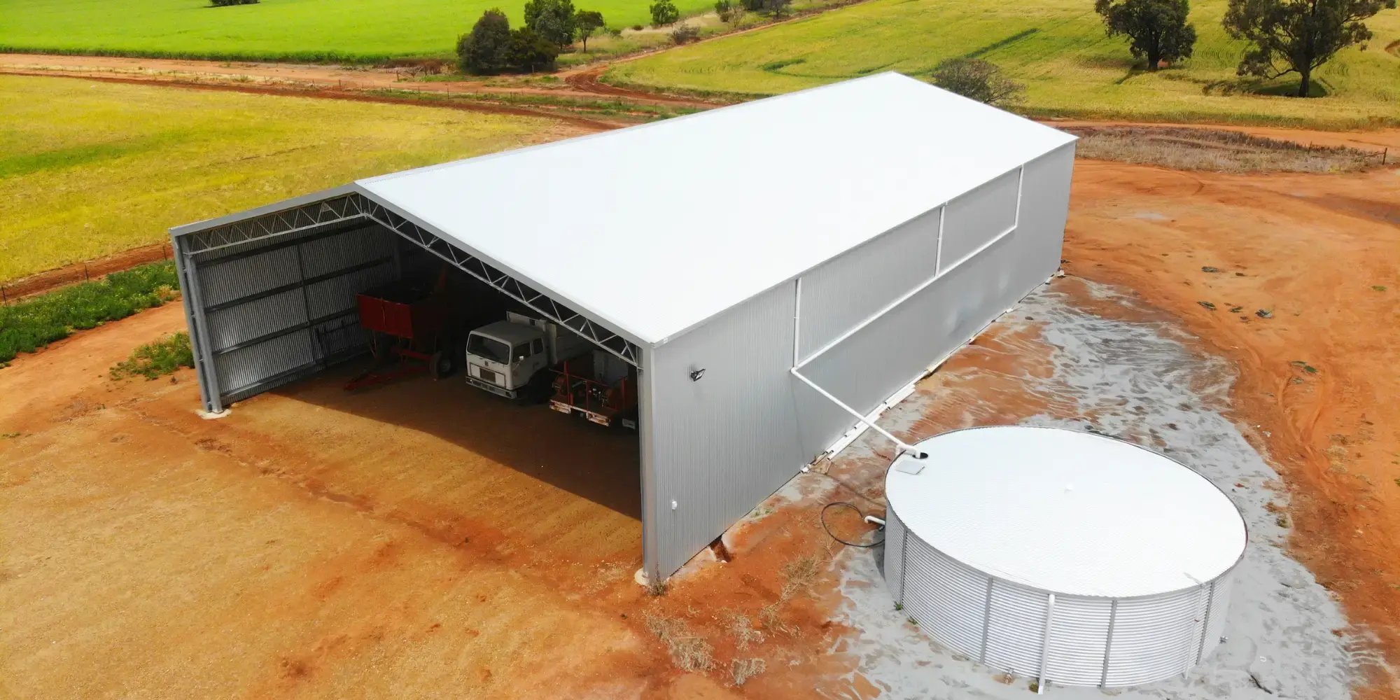 farm shed on rural property with rain water tank attached
