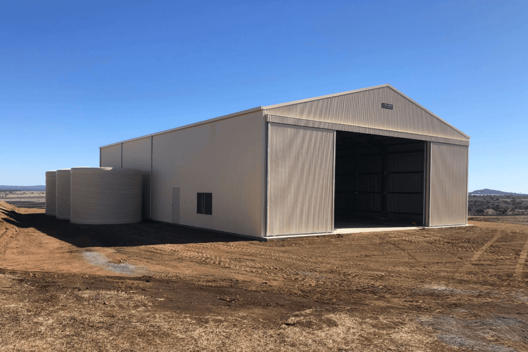 Farm machinery shed with sliding doors
