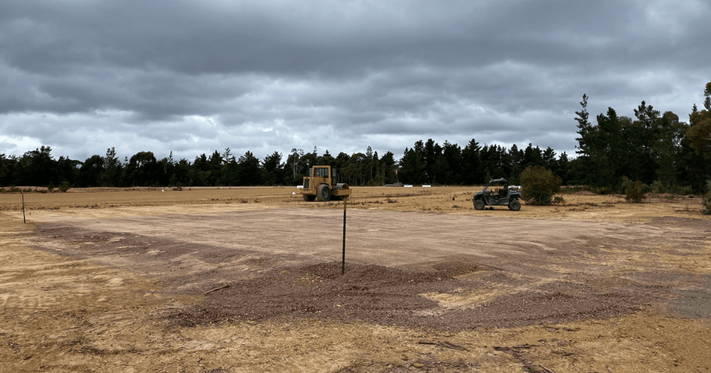 Level shed pad with rise for drainage