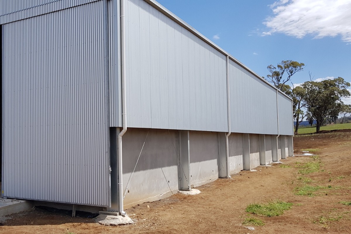 Side of cotton shed with concrete panels