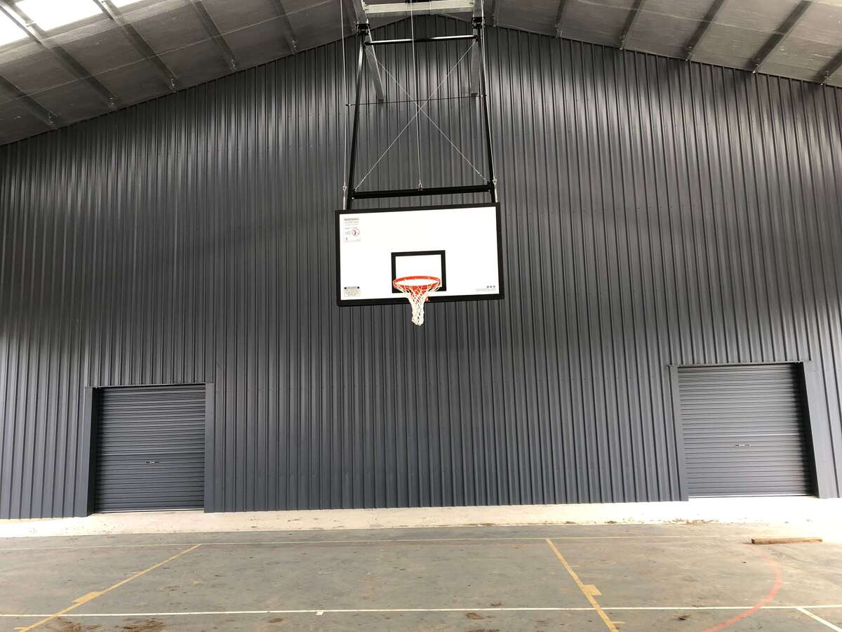 Inside view of cyclone rated shed with basketball hoop in Chelona