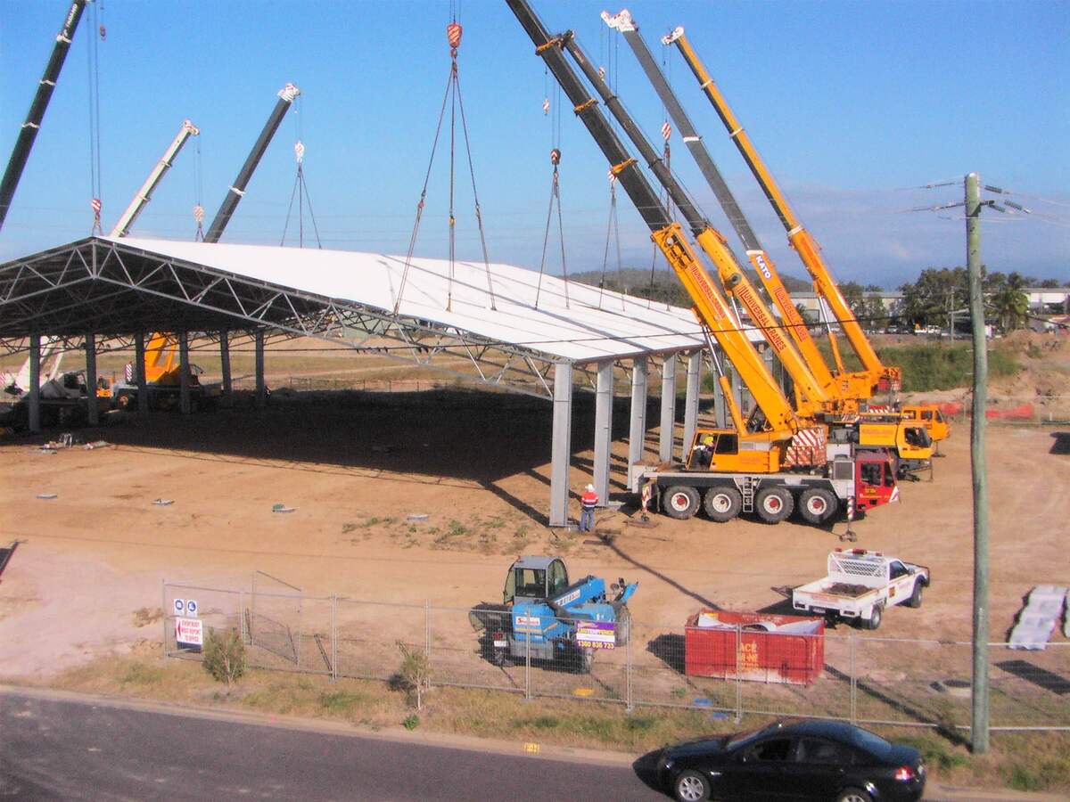 Cranes lifting cyclone rated shed into place in Townsville