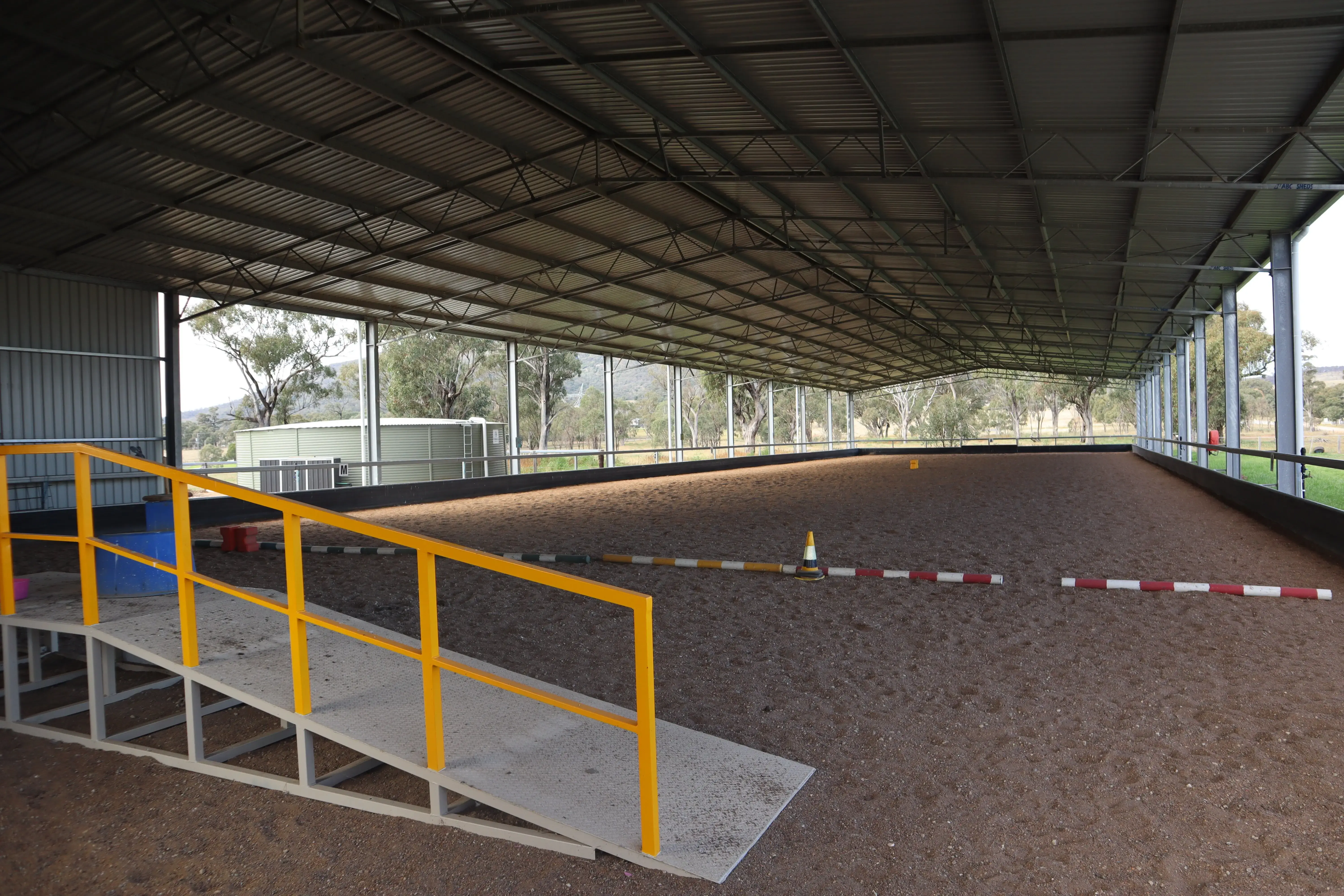 yellow rail ramp inside dressage arena