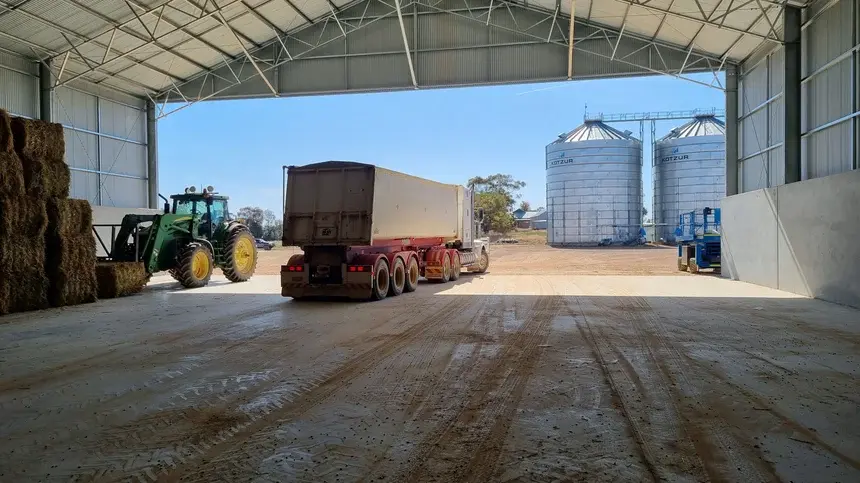 truck and trailer in a grain shed